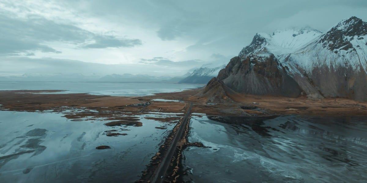 Aerial view of Iceland coastline with mountains, ice, and ocean