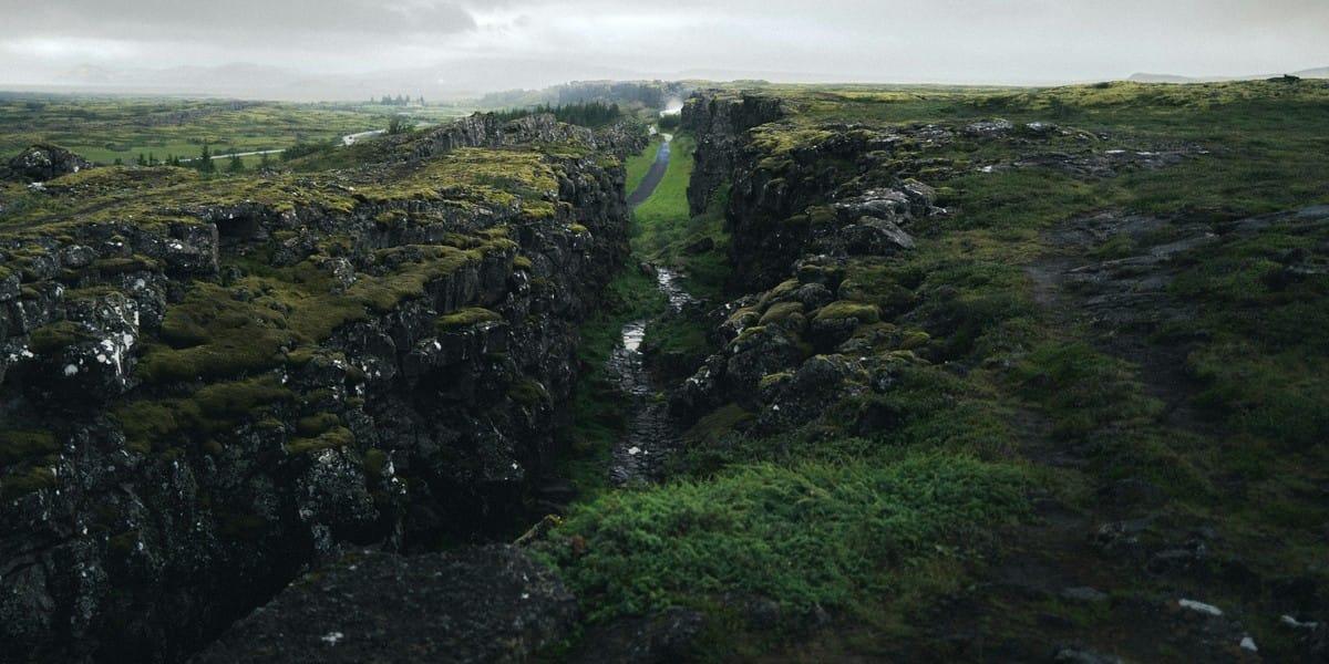 Icelandic landscape with moss-covered cliffs and cloudy skies
