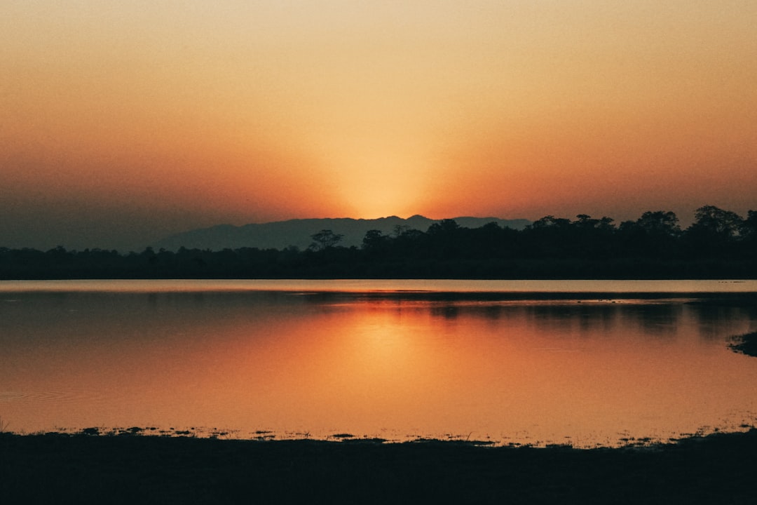 Sunset over Lake Apopka with bird silhouettes and photographers in foreground.