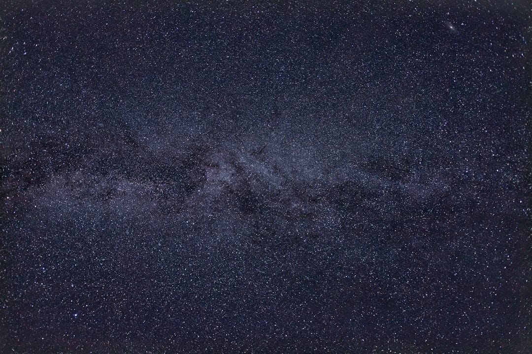 night sky milky way above texas hill country road with bluebonnets