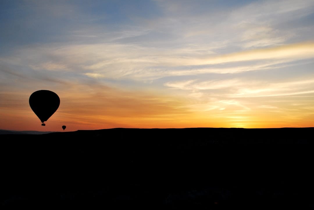 successful beginner bird photographer at Bosque del Apache sunset with telephoto lens