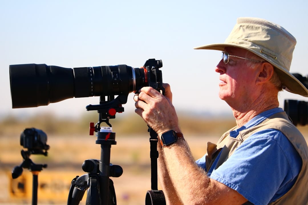 wildlife photographer using camping cot near hide for long stakeout comfort
