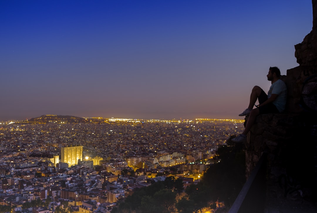 Sunset city skyline view from Bunkers del Carmel featured in barcelona travel guide.