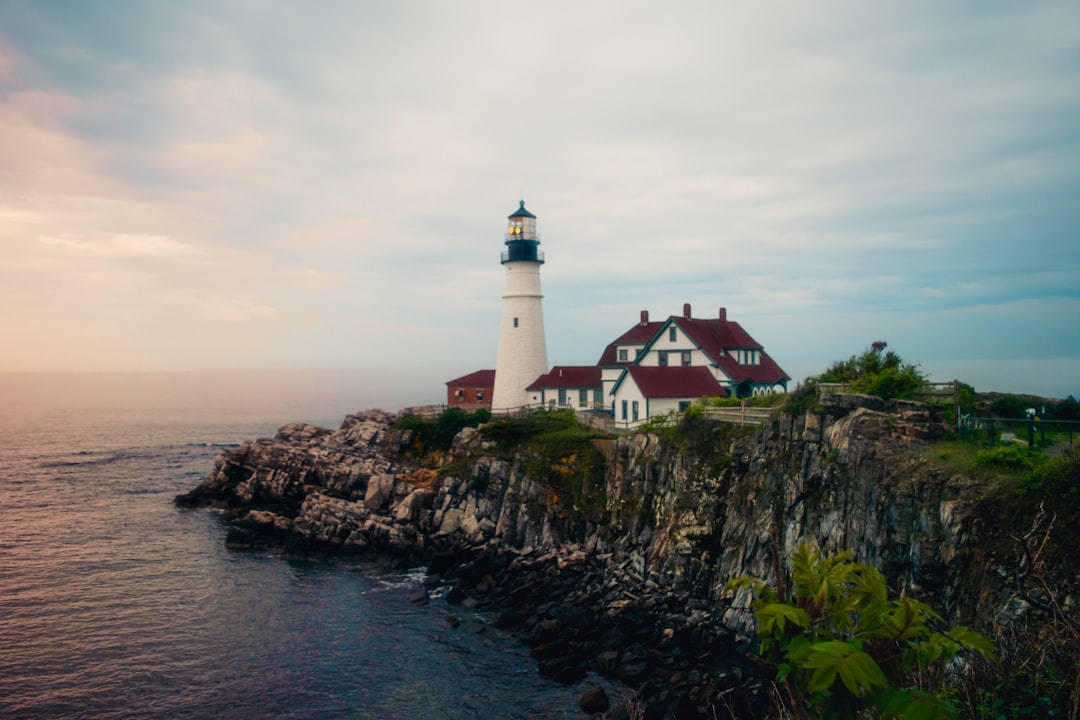 A scenic lighthouse on the rocky coast from the Maine travel guide.